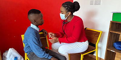 A student nurse interacts with a child