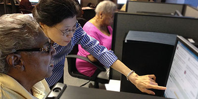 a nurse researcher helping a patient with a patient portal