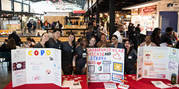 Students have posters of health issues at Lexington Market