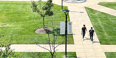 two students walk on USG's campus
