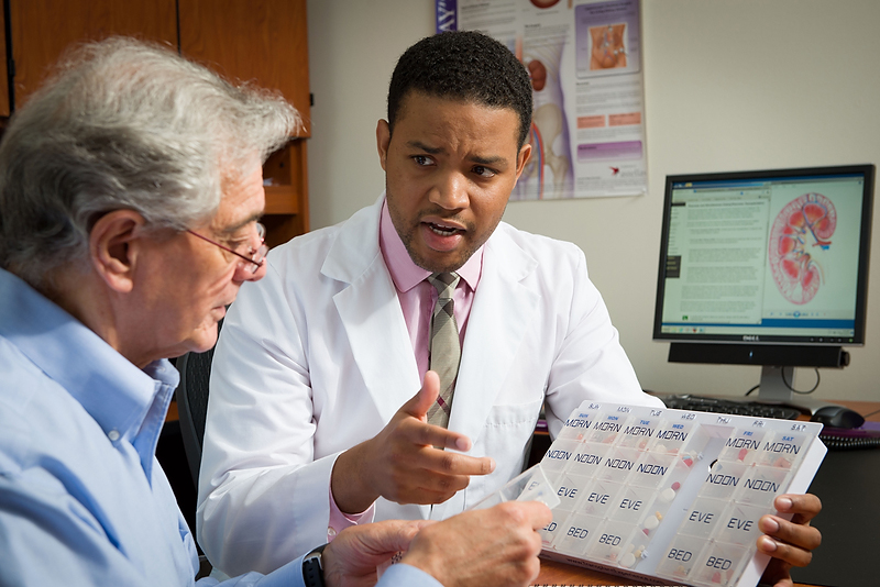 a doctoral student talks with someone about his research