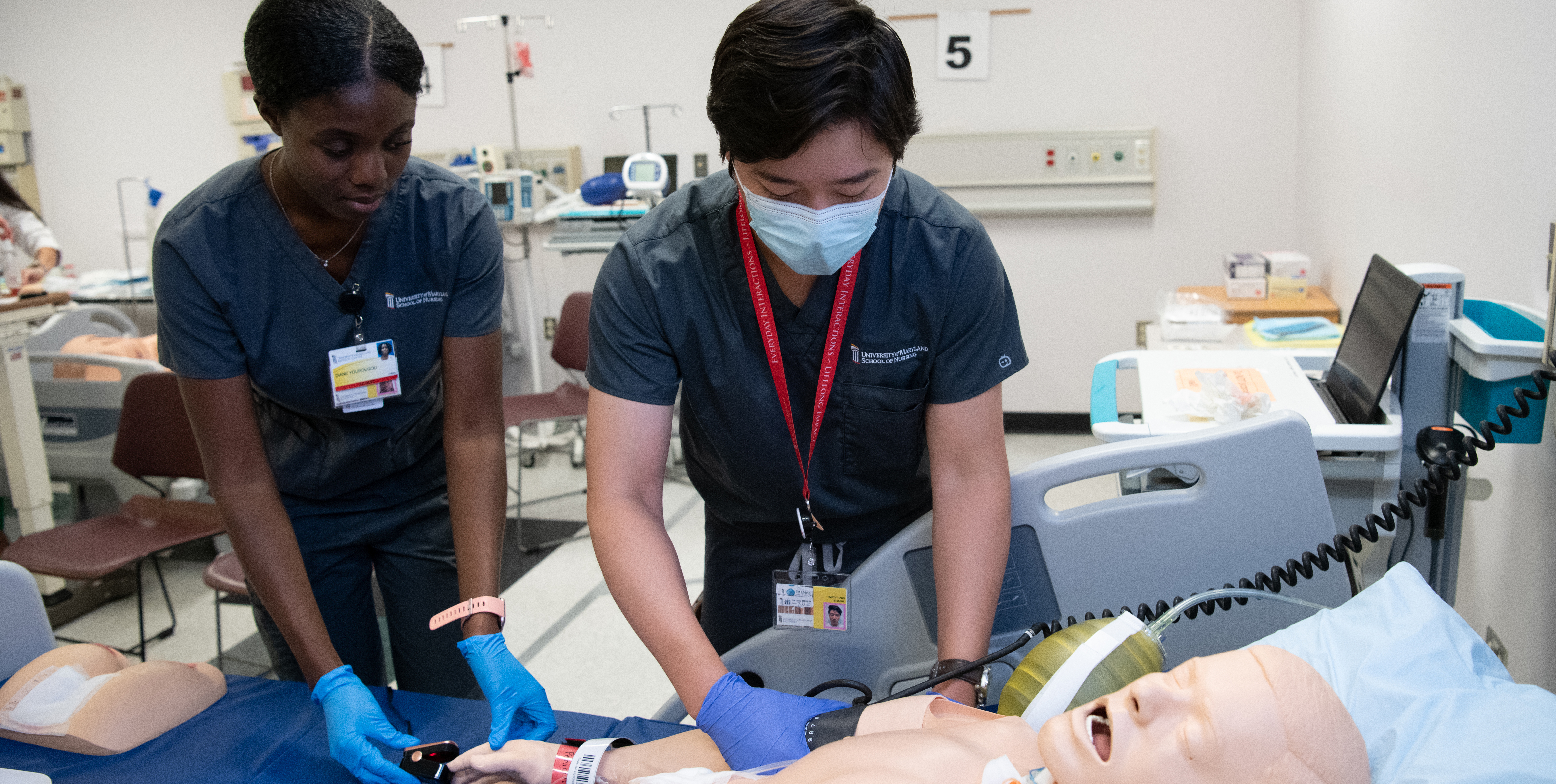 Two Nursing Students working on a simulation patient