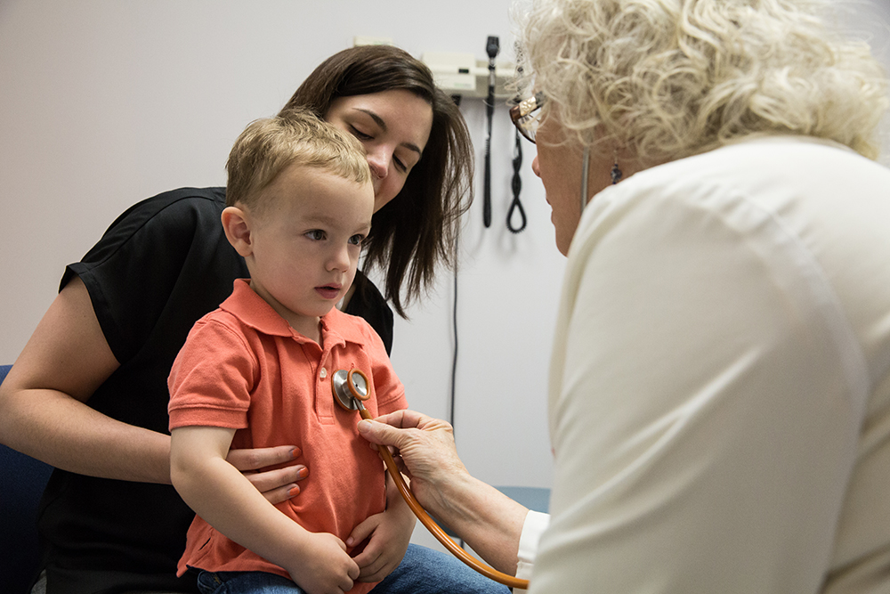 a nurse practitioner meets with a child