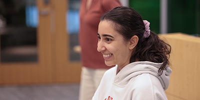 A female student smiles in a classroom