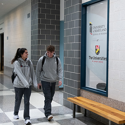 A male and female student walk the halls at USG