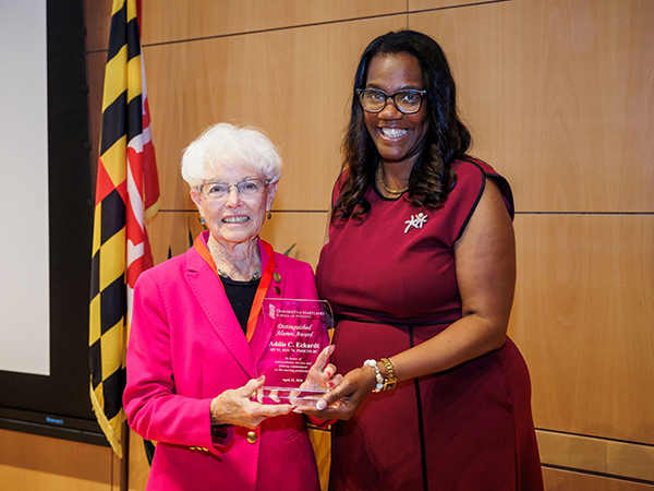 Addie C. Eckardt receiving the Distinguished Alumni Award from Dean Ogbolu