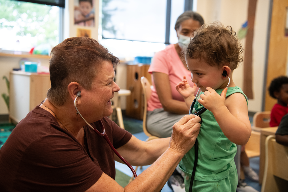 Laura Allen checks the heartbeat of a young patient.