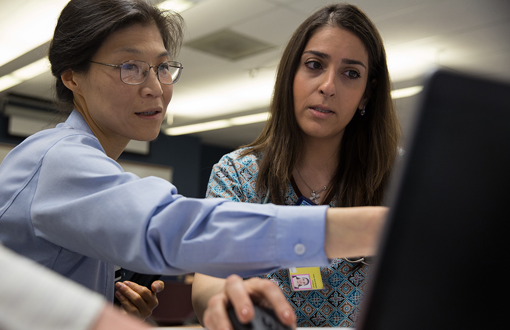 Eun-Shim Nahm interacts with a nurse at a nurse's station