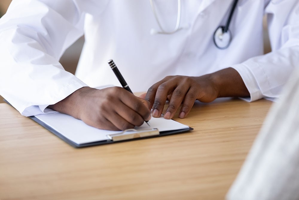 Hands of a nurse writing