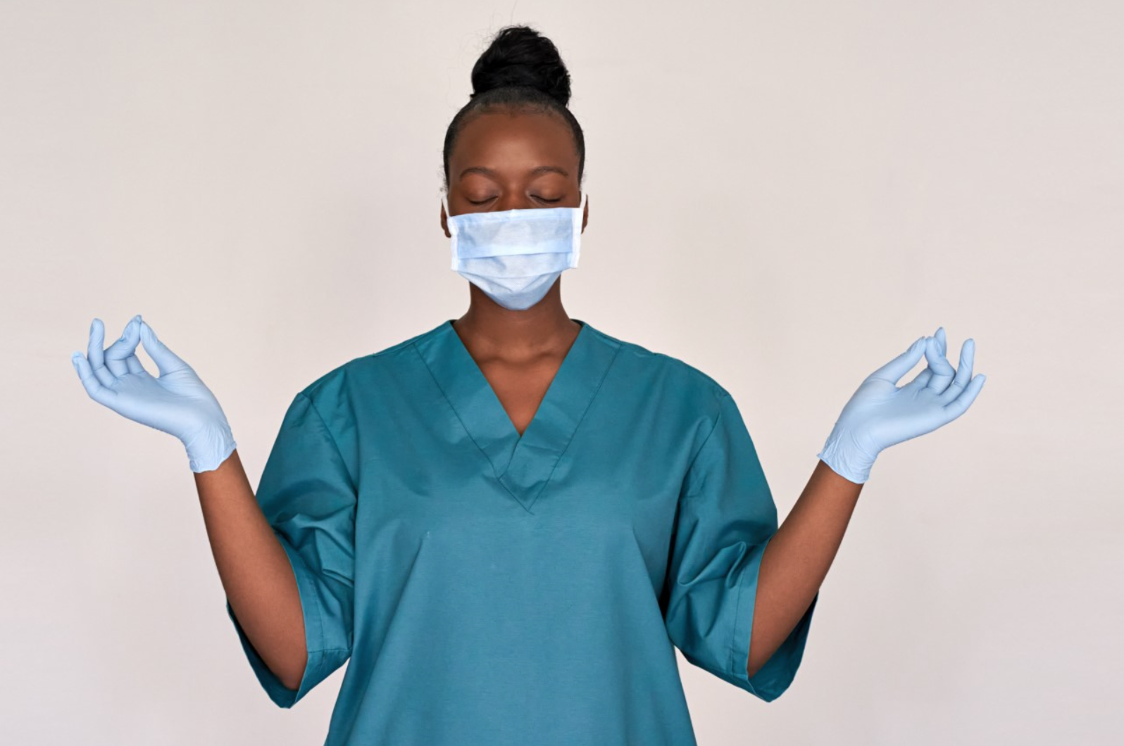 a nurse with hands outstretched in meditation poses