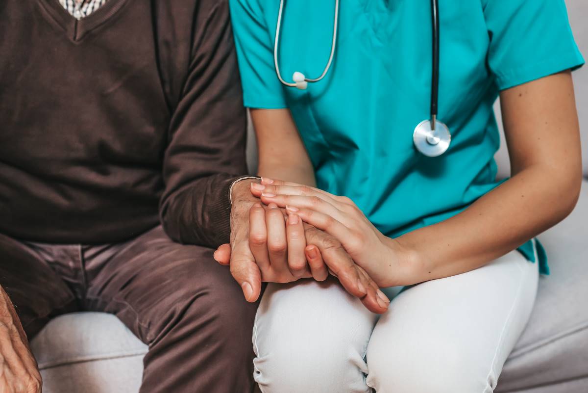 nurse holding hands with patient 