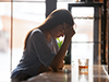 thumbnail image of a woman at a bar with a drink next to her