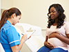 a nurse talking with a pregnant woman