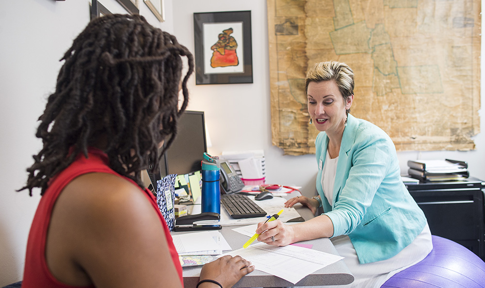 a Student Success Center employee chats with a student