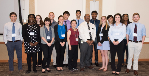 Gregory B. Carey, PhD, (fourth from right, front row) stands with UM Scholars at a recent Student Research Forum. Carey oversees the program in which undergraduate students are paired up with mentors and conduct graduate-level research.